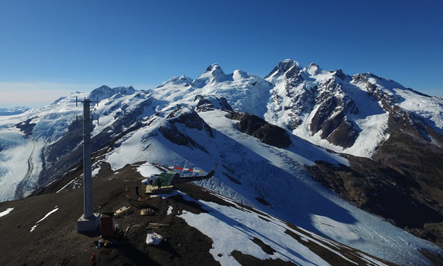 Most of their project sites are only accessible via a morning helicopter commute. Here, the helicopter is on a snowy mountaintop.