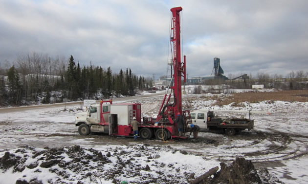 A large mining drill situated on a snowy field