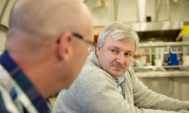 Tom Paddon sitting at a table with another man.