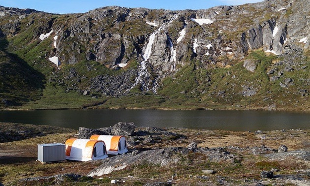 Water fall & small lake at North American Nickel Exploration Camp site with 2 Core Logging Tents in foreground.