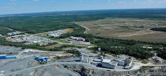 An aerial photo of the Sigma Milling Facility looking Southeast towards the Lamaque South Property. A drill can be seen operating on the Parallel Zone (the yellow dot within the treeless area).