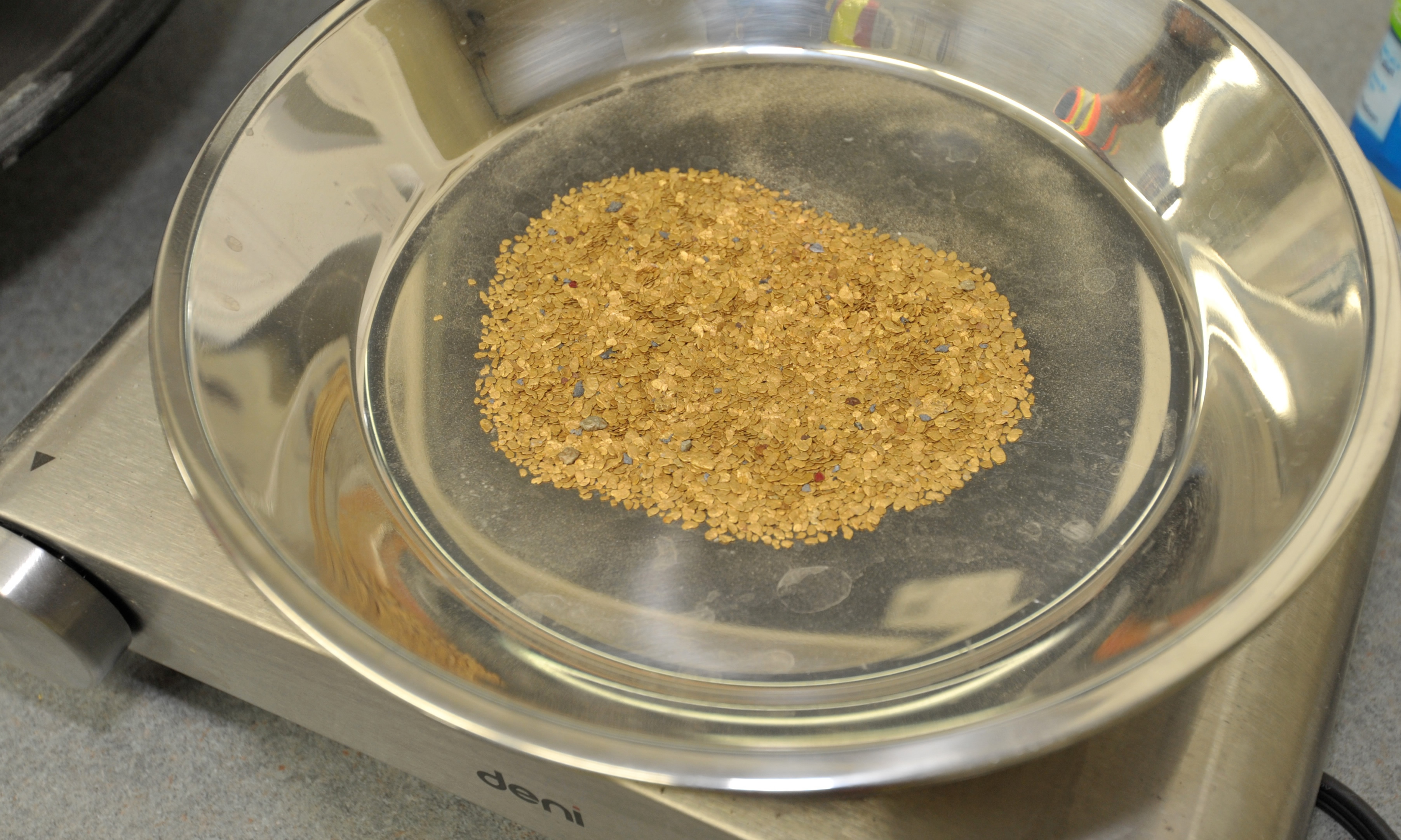 a shiny silver pan with gold in it